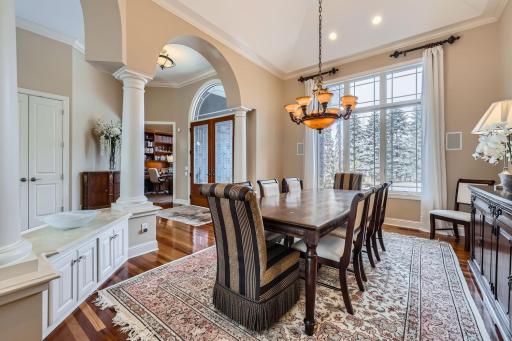 Another view of the formal dining room with pillars and lower built-in's