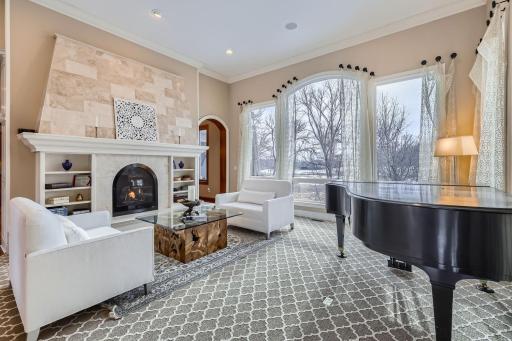 Stunning main floor living room with gas fireplace and 12 ft ceilings