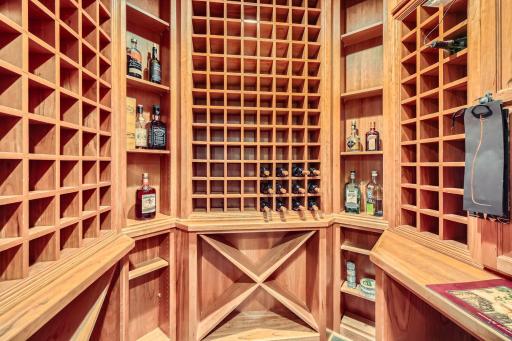 Large walk-in temperature controlled wine cellar next to wet bar