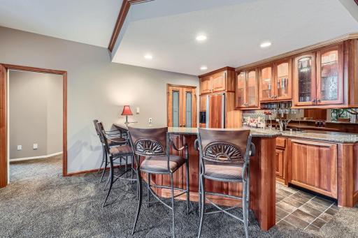 Fabulous lower level full-service wet bar with huge sit-up countertop