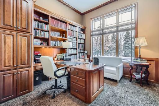 Main floor office with matching cherry woodwork desk, cabinets and bookshelves