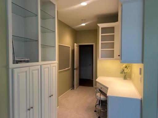 Lower level bedroom with build-in desk and cabinets