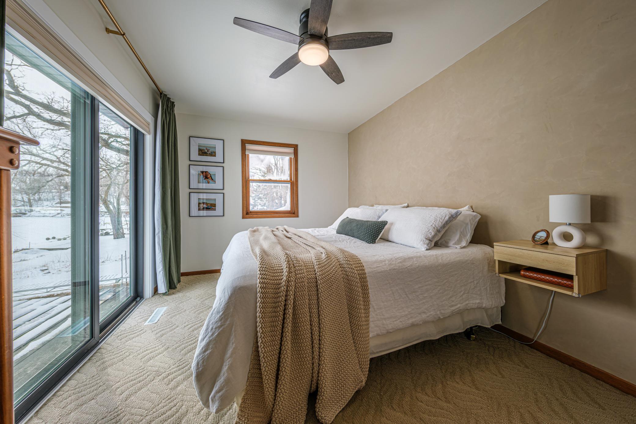 Primary bedroom features a patio door to a private balcony, a walk-in closet, and a roman clay feature wall.