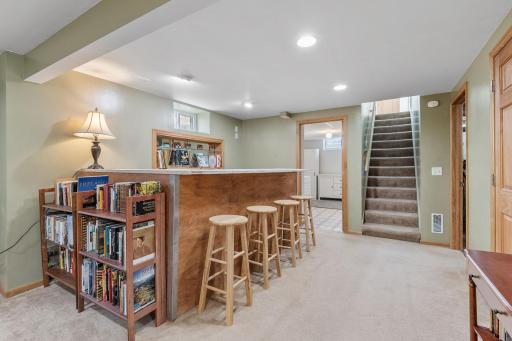 The finished lower level expands your living space with a bar, second fireplace, half bathroom, laundry area, and ample storage.