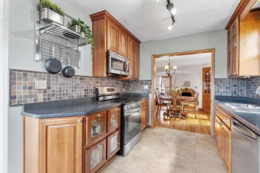 The light-filled kitchen is equipped with stainless steel appliances, warm wood cabinets, and plenty of counter spaceâperfect for home cooks and entertainers alike.
