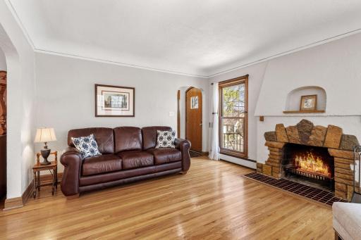 Beautiful wood floors, classic archways, and a cozy wood-burning fireplace