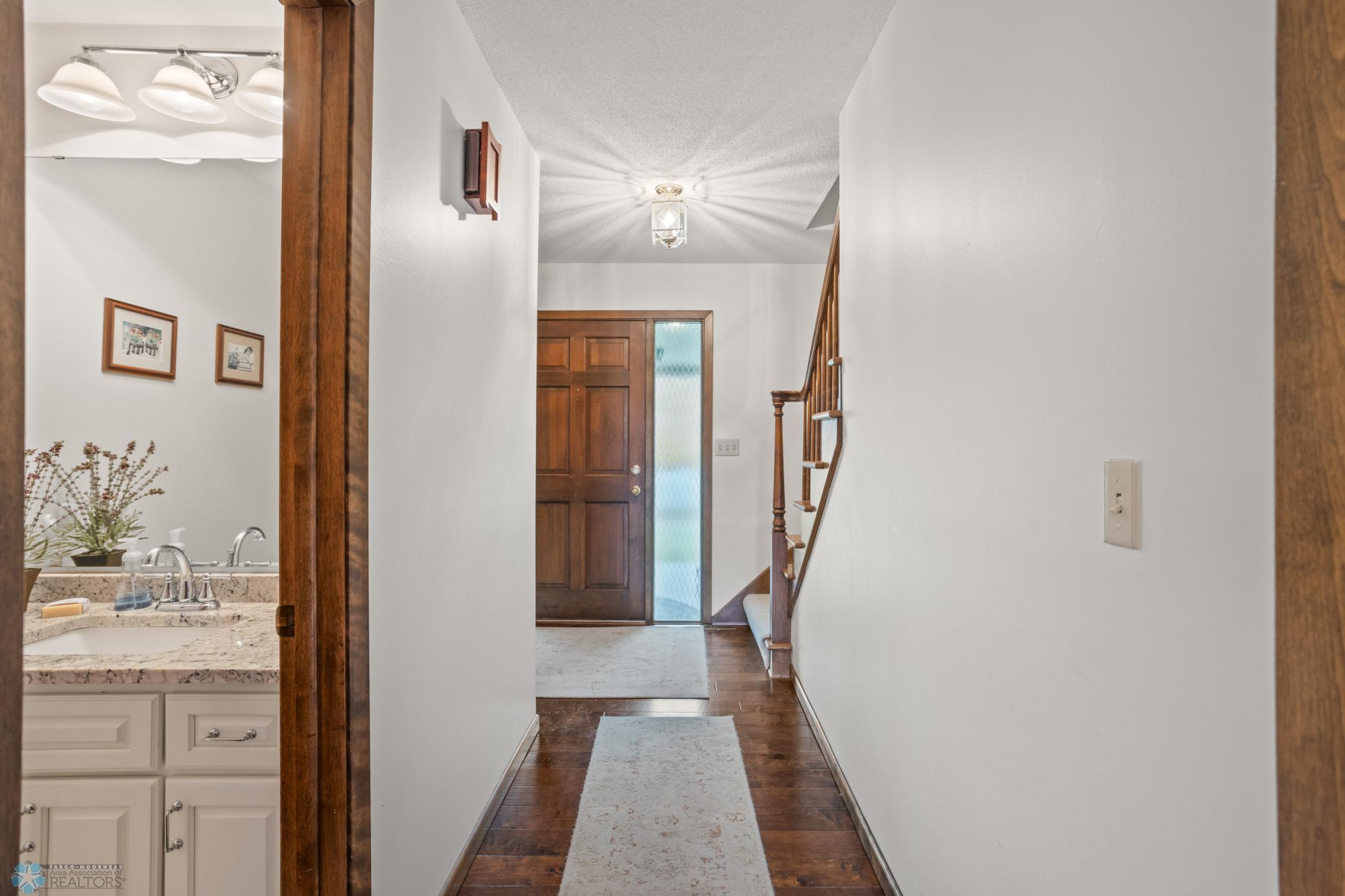 From Kitchen/Back Living Looking toward 3/4 bath and front stairwell