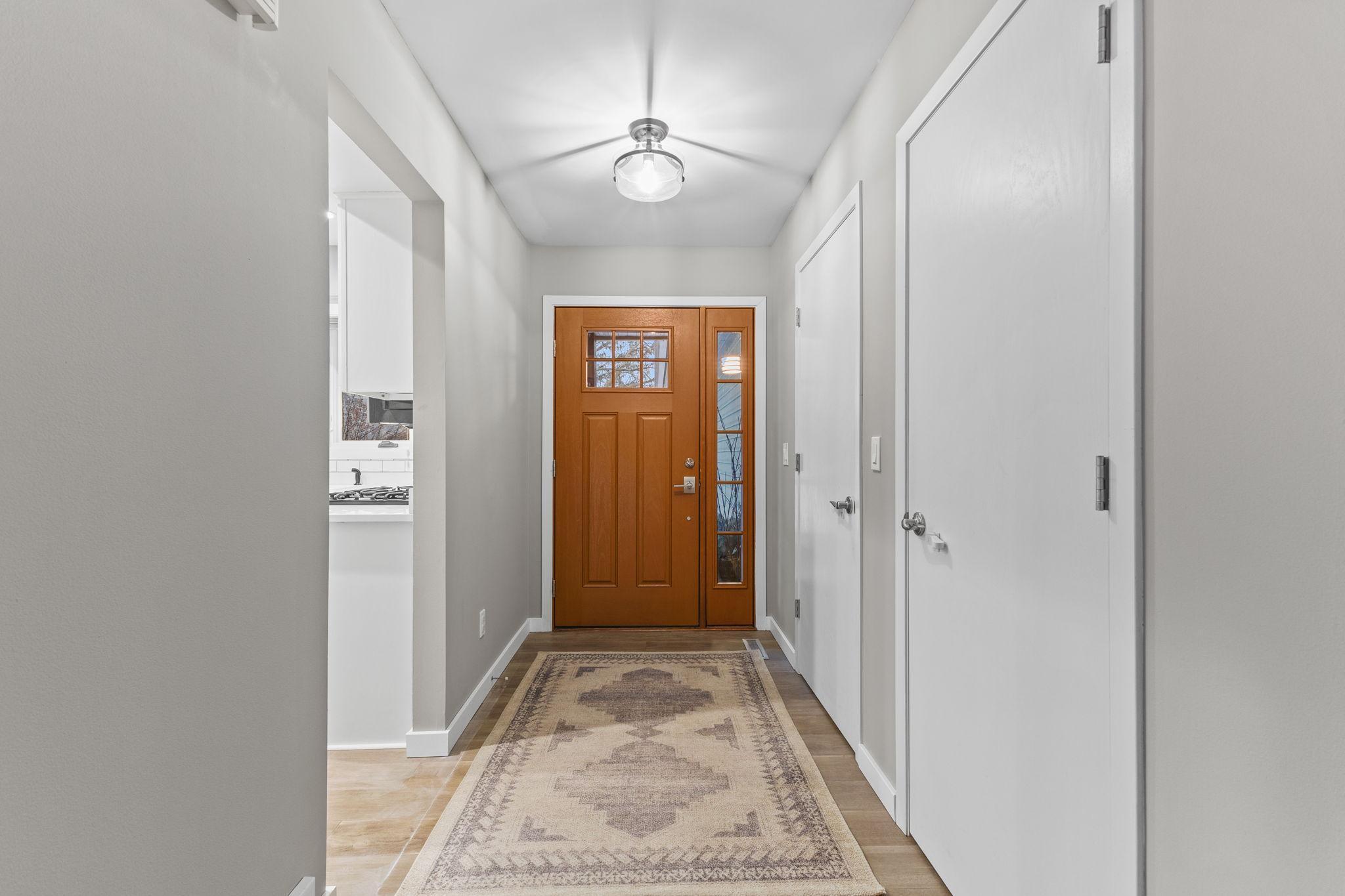 A spacious front foyer of this updated single family home located in southeastern Eden Prairie, just north of the Minnesota River. Fresh paint and new floors! The doors to the right are the main level laundry and a front entry closet.