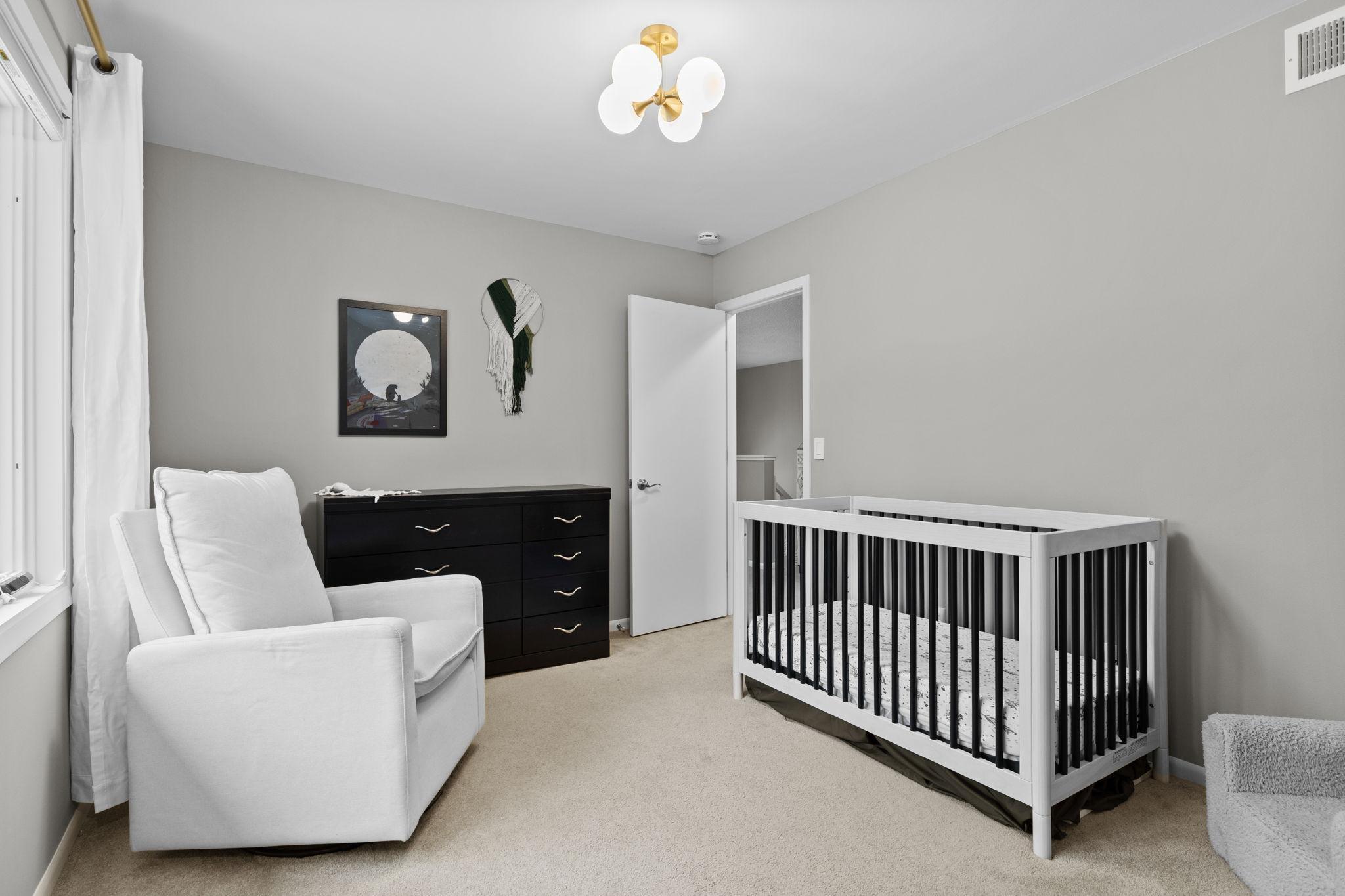 The upper level second bedroom. The bedroom faces the backyard of the home.