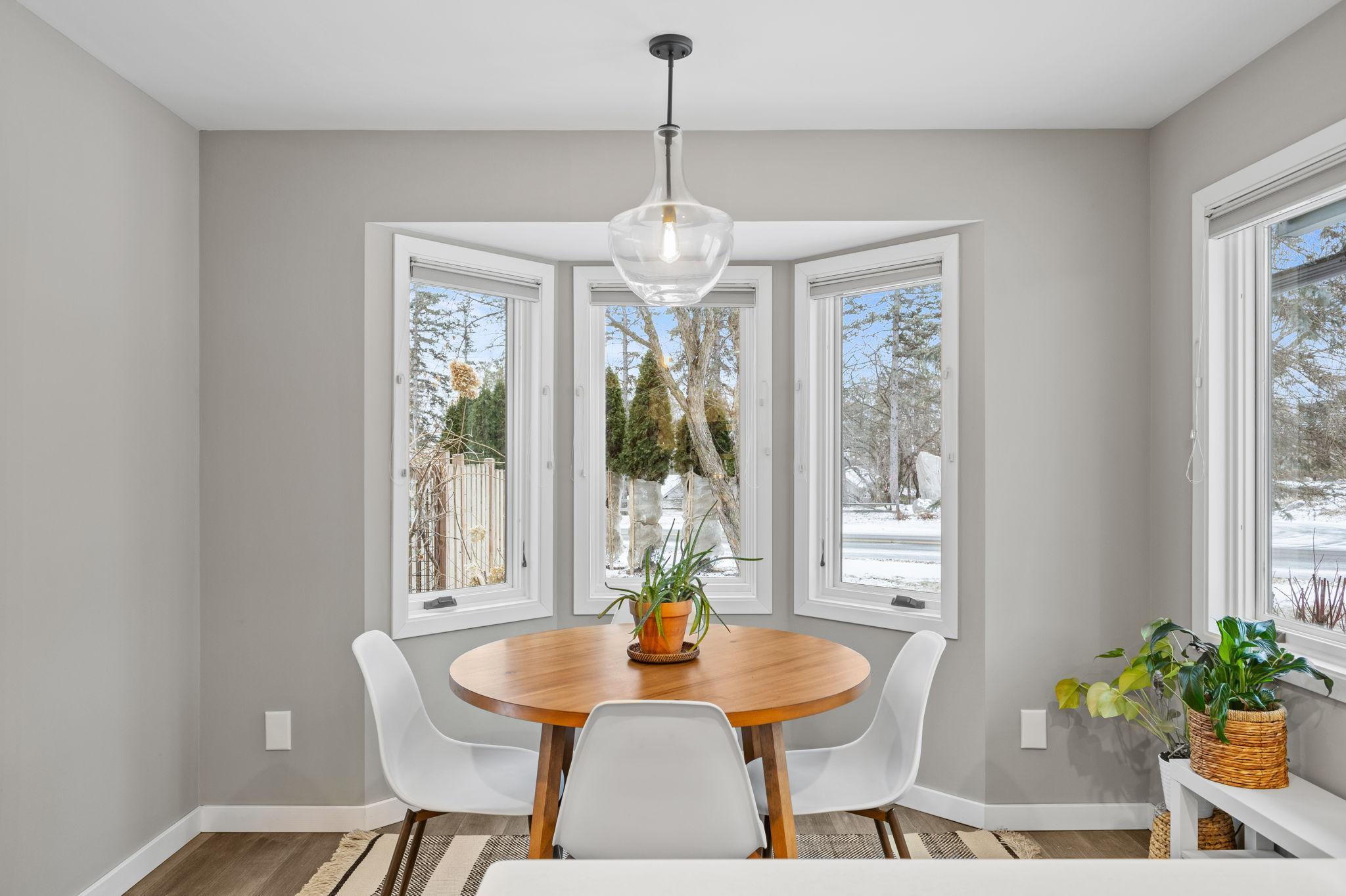 This is the perfect blend of warmth and modern elegance in this cozy dining nook. Bathed in natural light from the stunning bay windows, this space invites you to enjoy your morning coffee while soaking in picturesque outdoor views.