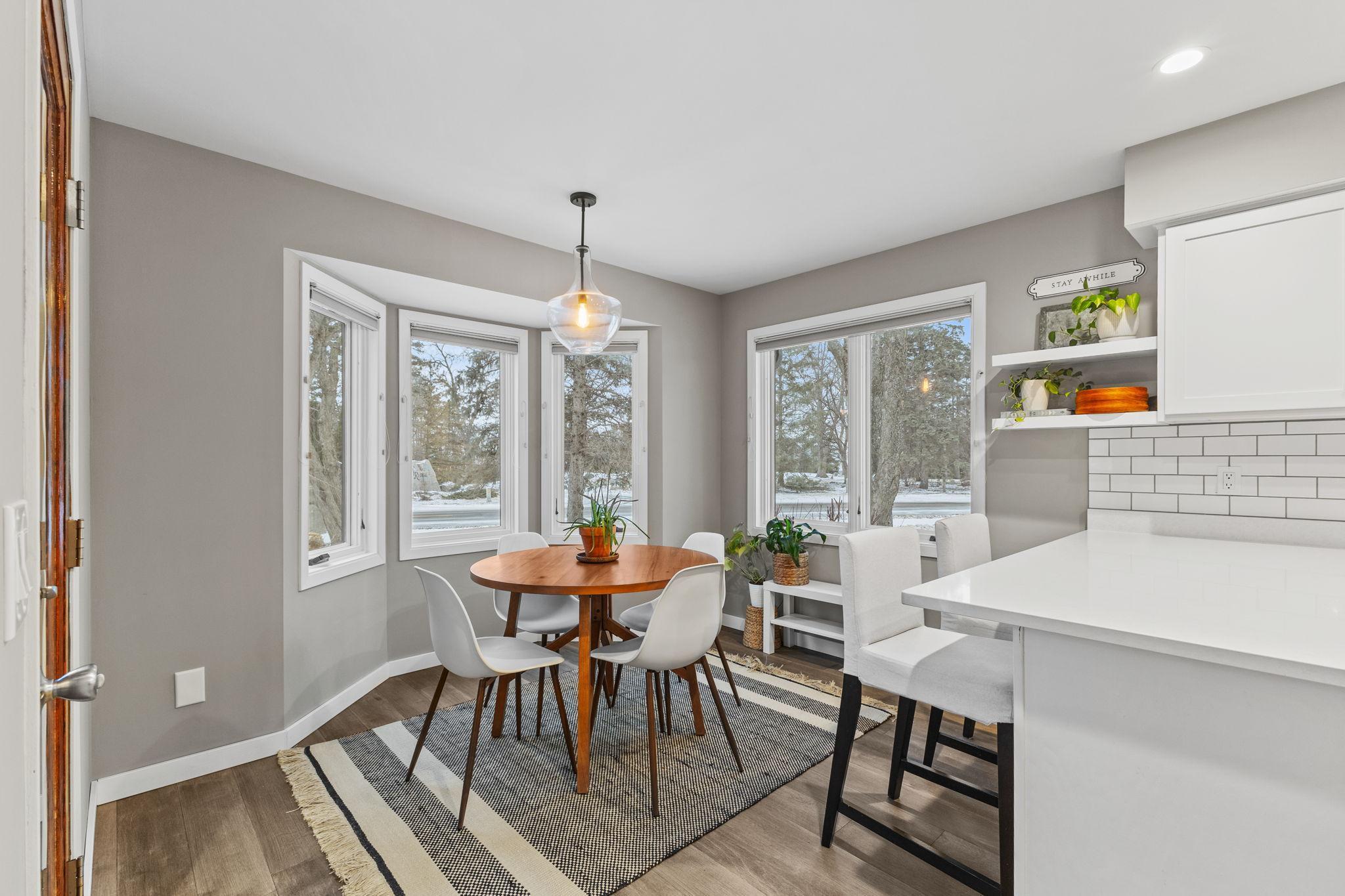 An alternate view of the eat-in kitchen area. The door to the left will take you to the maintenance-free deck and absolutely stunning, private, and lush backyard.