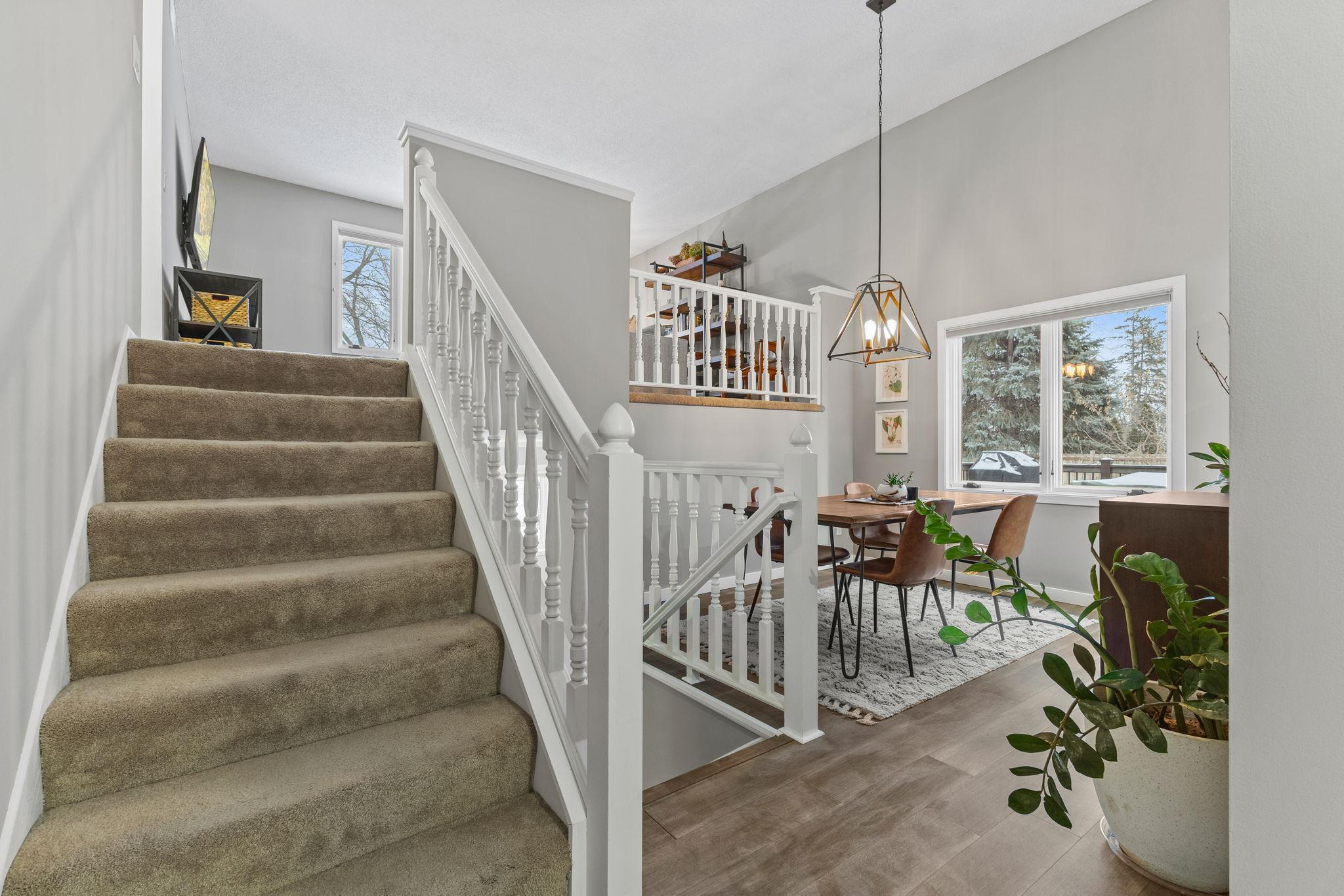 This is a view from the front entry way. New floors, fresh paint, updated fixtures and much more. The windows overlook the maintenance-free deck and face the south side of the property.