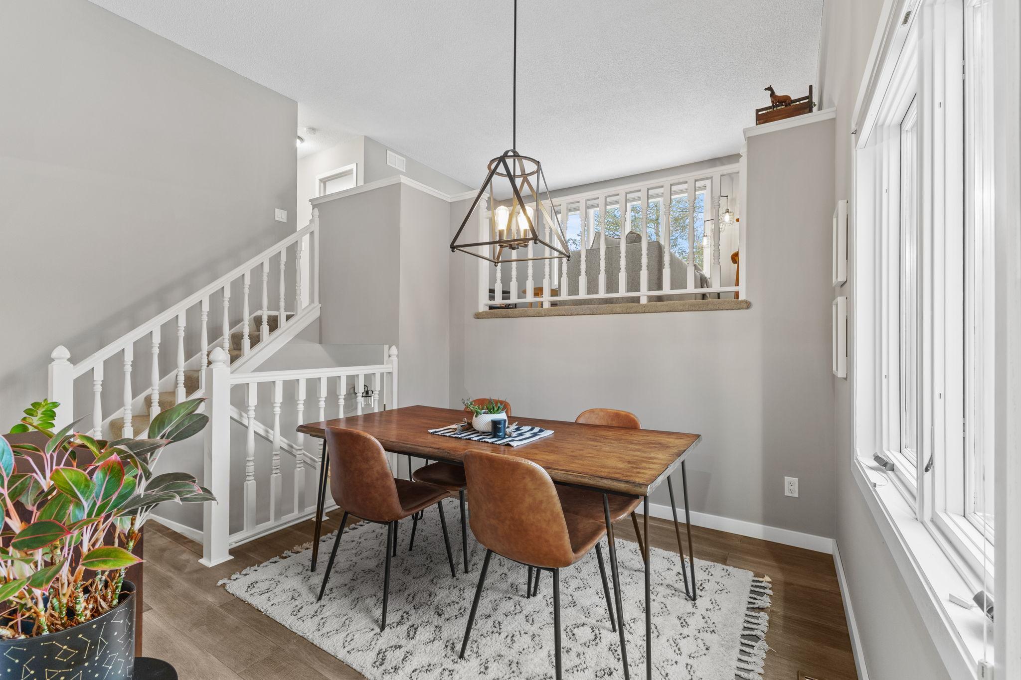 Natural light pours in through the large window, creating an inviting ambiance perfect for intimate dinners or lively gatherings. The open, multi-level layout enhances the home's spacious feel!