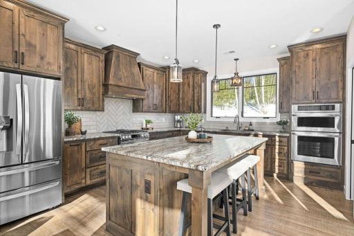 Chef's kitchen with custom venthood and cabinetry!