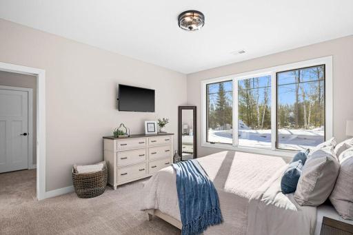 Main floor primary ensuite bedroom with walk in closet!