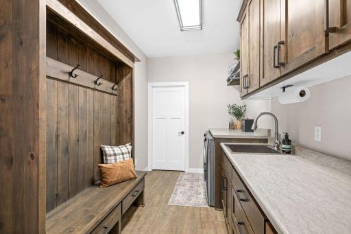 Mudroom with built in wall unit right off of the heated 3 car garage!
