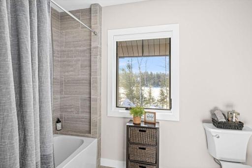 Tiled shower/tub and separated by a door from vanity area!