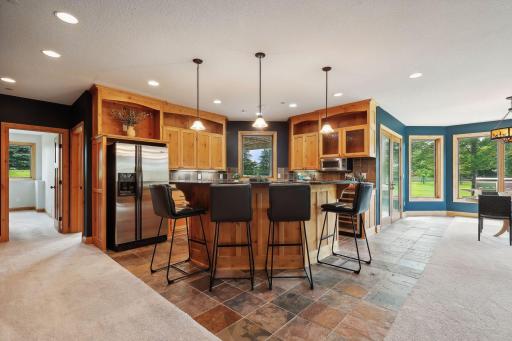 Wet Bar with island seating, full size fridge as well as a beverage fridge