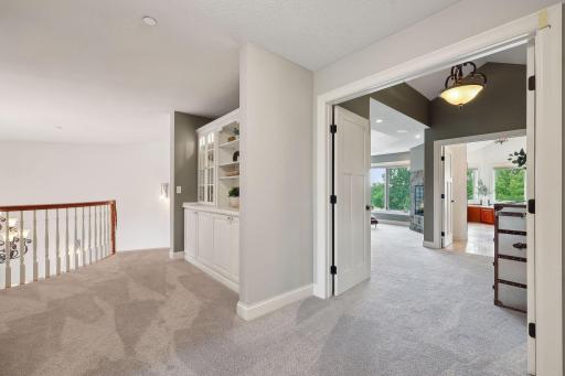 Custom Built ins at the top of the grand foyer leading into the primary suite