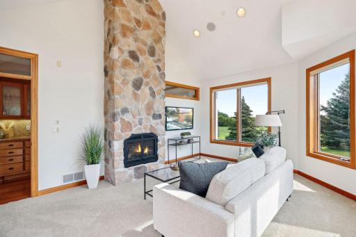 floor to ceiling stone gas fireplace in the sunroom