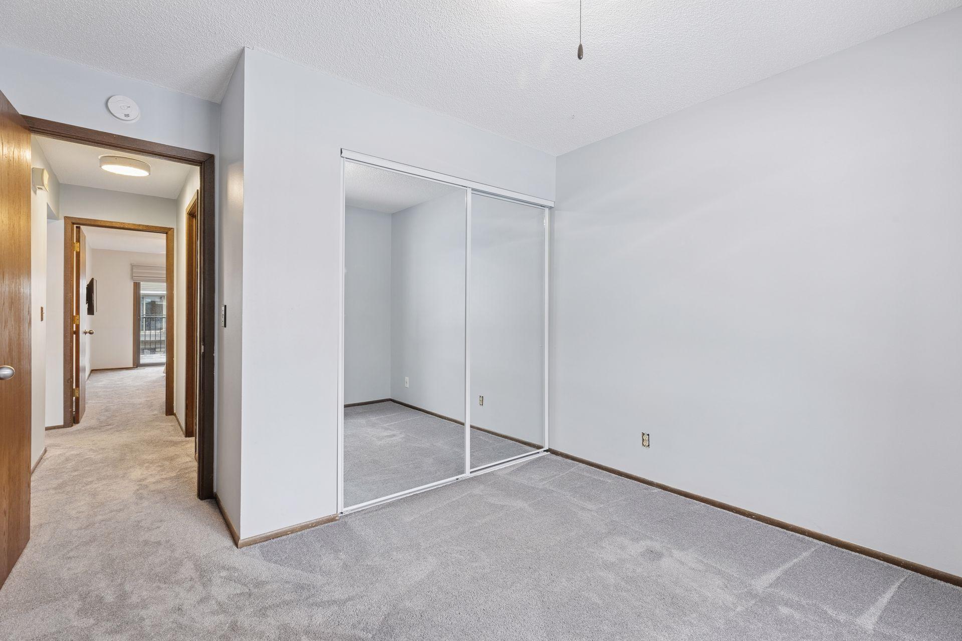 2nd Bedroom newer mirrored closet door. Newer carpeting installed