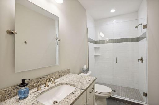 Lower level 3/4 bathroom with a walk-in shower