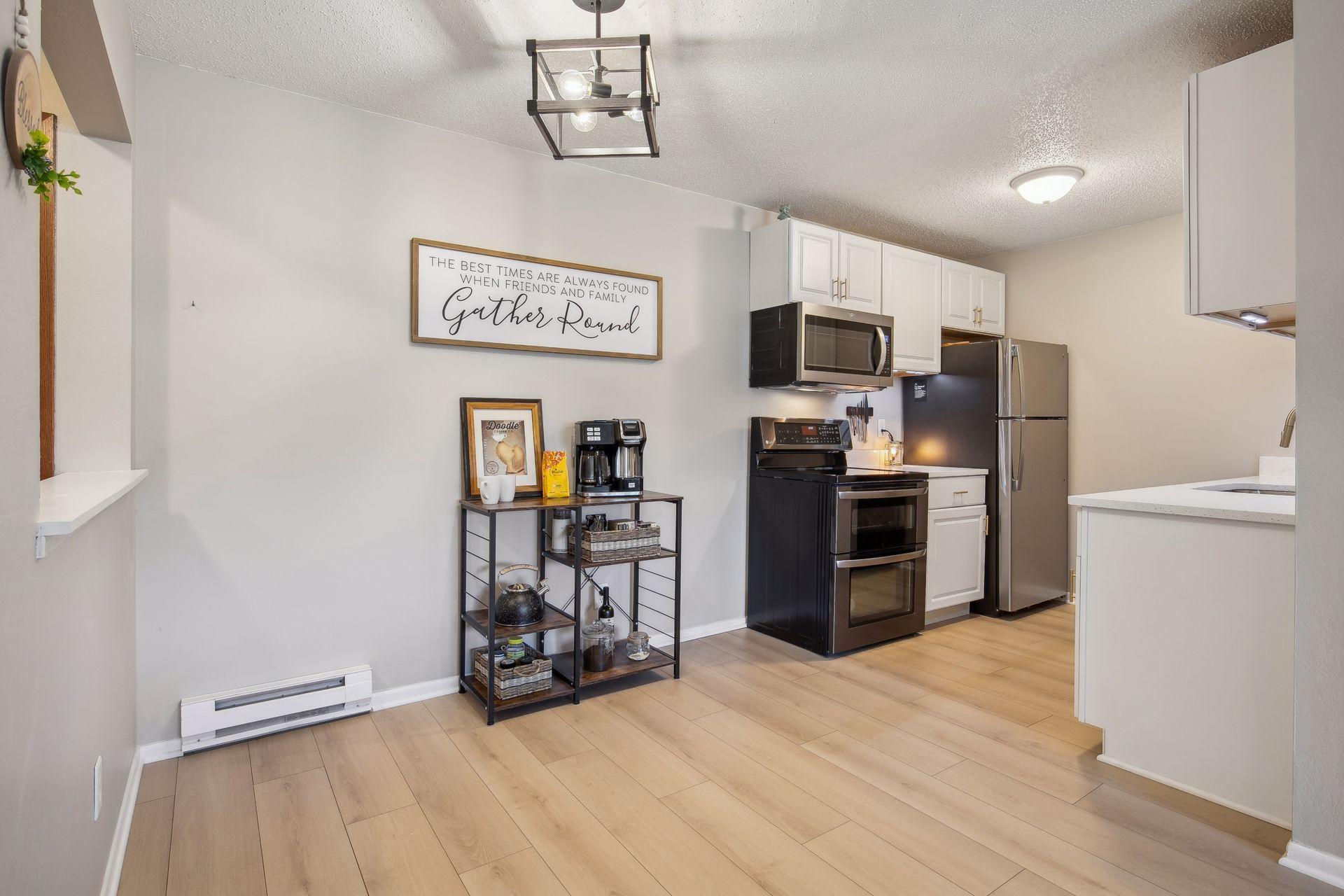 Gleaming new white oak flooring, designer paint colors, and abundant light fill the dining are of this home