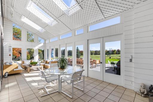 Sunroom inviting family and guests to the peaceful surround of meadows, a pond, and distant tree lines