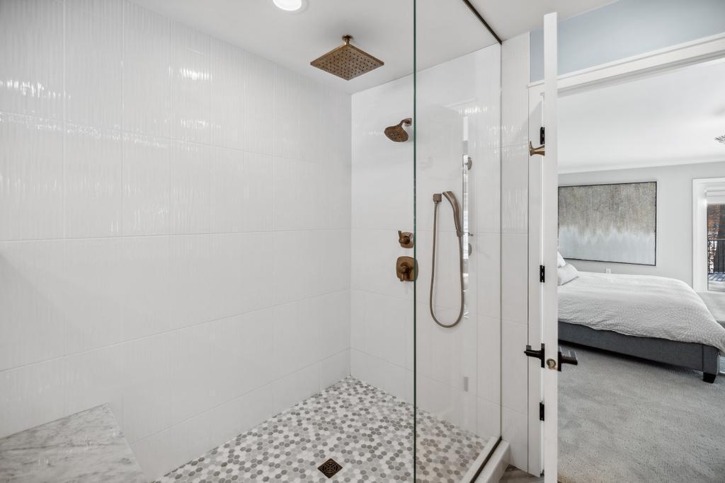 Thoughtful details, from the plantation shutters to the rich bronze fixtures, complete the space, making it the ideal place to begin and end your day in absolute comfort.