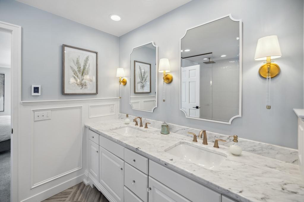 The spacious dual bowl vanity provides ample room for both partners to prepare for the day ahead.