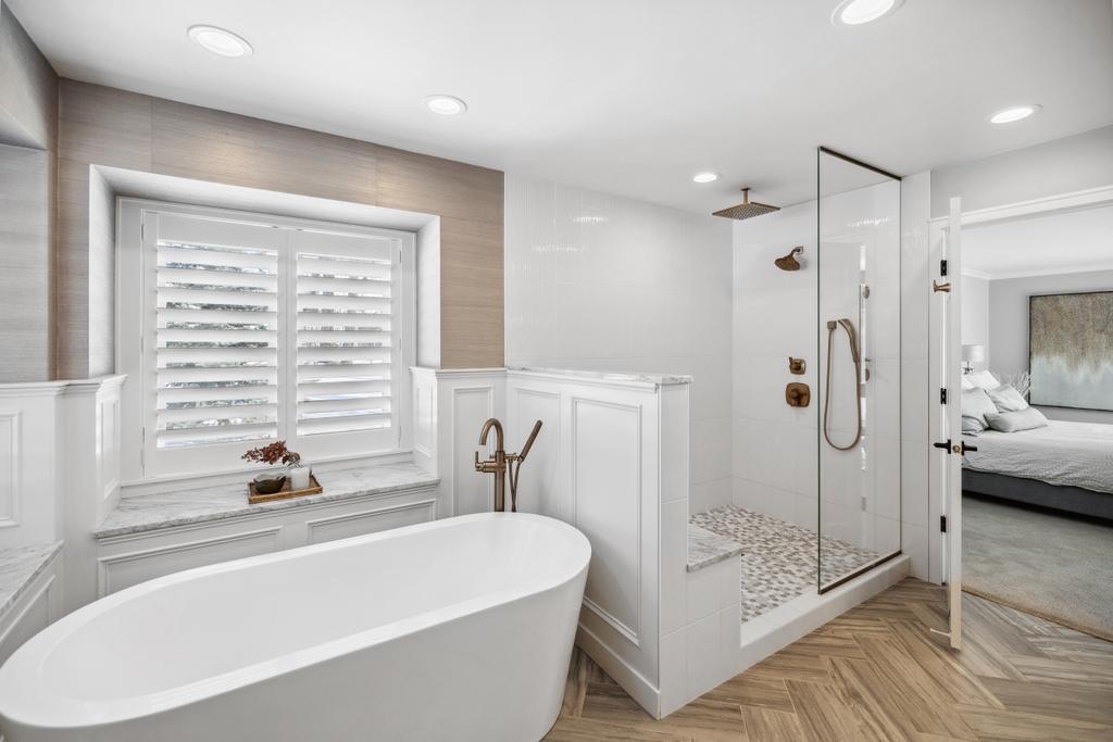 The freestanding soaking tub offers the perfect setting for relaxation, whether you’re immersed in a good book or savoring a glass of wine.