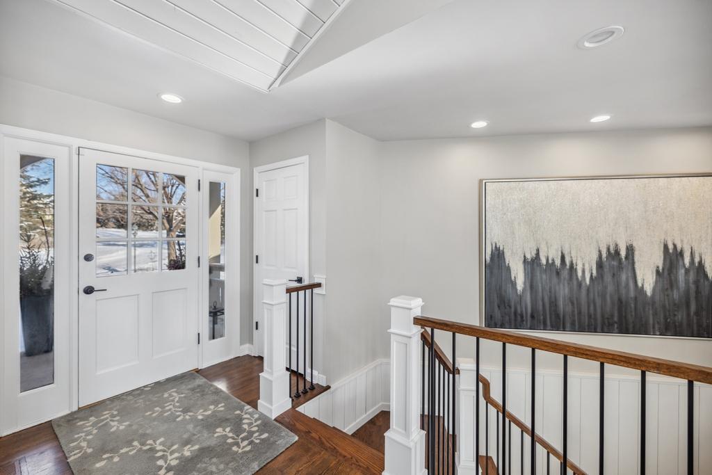 An entryway that makes a statement — this home invites you in with warmth, natural light, and stunning sightlines to the lake.