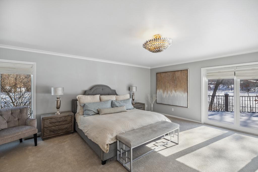 Natural light pours in through large windows, offering sweeping views of the lake and surrounding landscape.