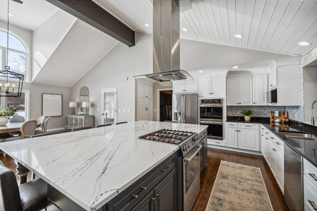 The double ovens offer the flexibility to prepare multiple dishes at once, making entertaining a breeze, while roll-out cabinetry ensures that every cullinary essential is always within reach.