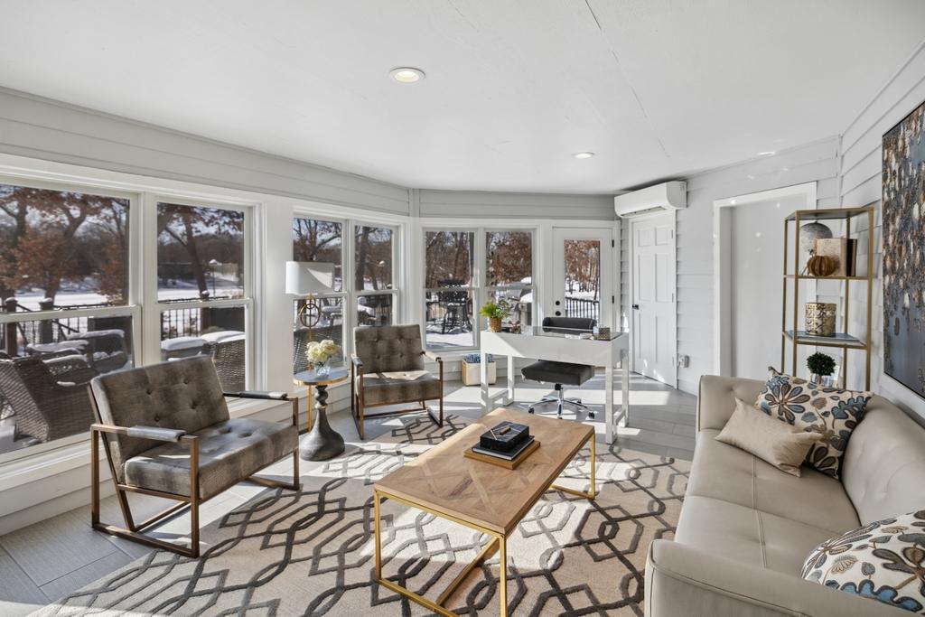 The 4-season sunroom is a versatile space where natural light pours in from every direction.