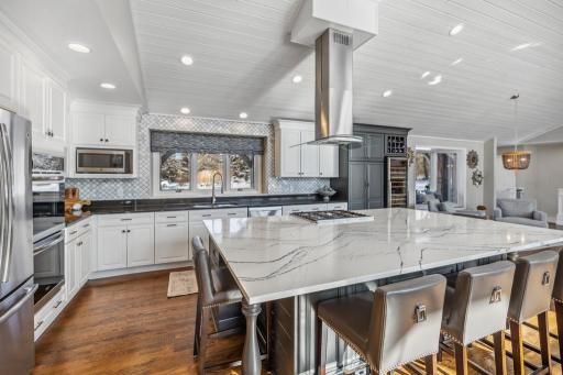 The expansive 10-foot center island, with a luxurious quartz countertop, provides the ideal space for preparing gourmet meals or serving appetizers.