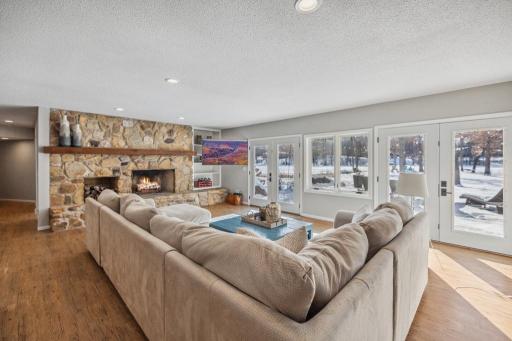 French doors flanked by windows, showcase breathtaking lake views and lead directly to the patio and backyard.