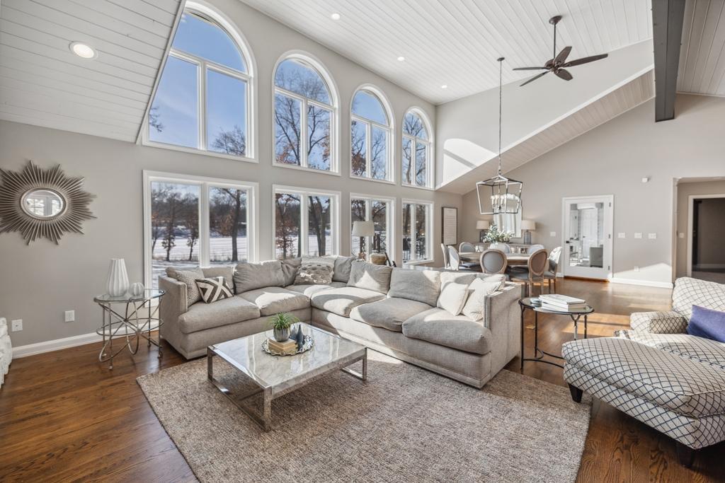Bathed in natural light from stunning floor-to-ceiling arched windows, the living room is a space where refined design meets effortless comfort.