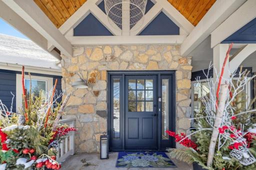 First impressions matterâthis vaulted portico with rich wood detailing and a striking light fixture creates an unforgettable entrance.