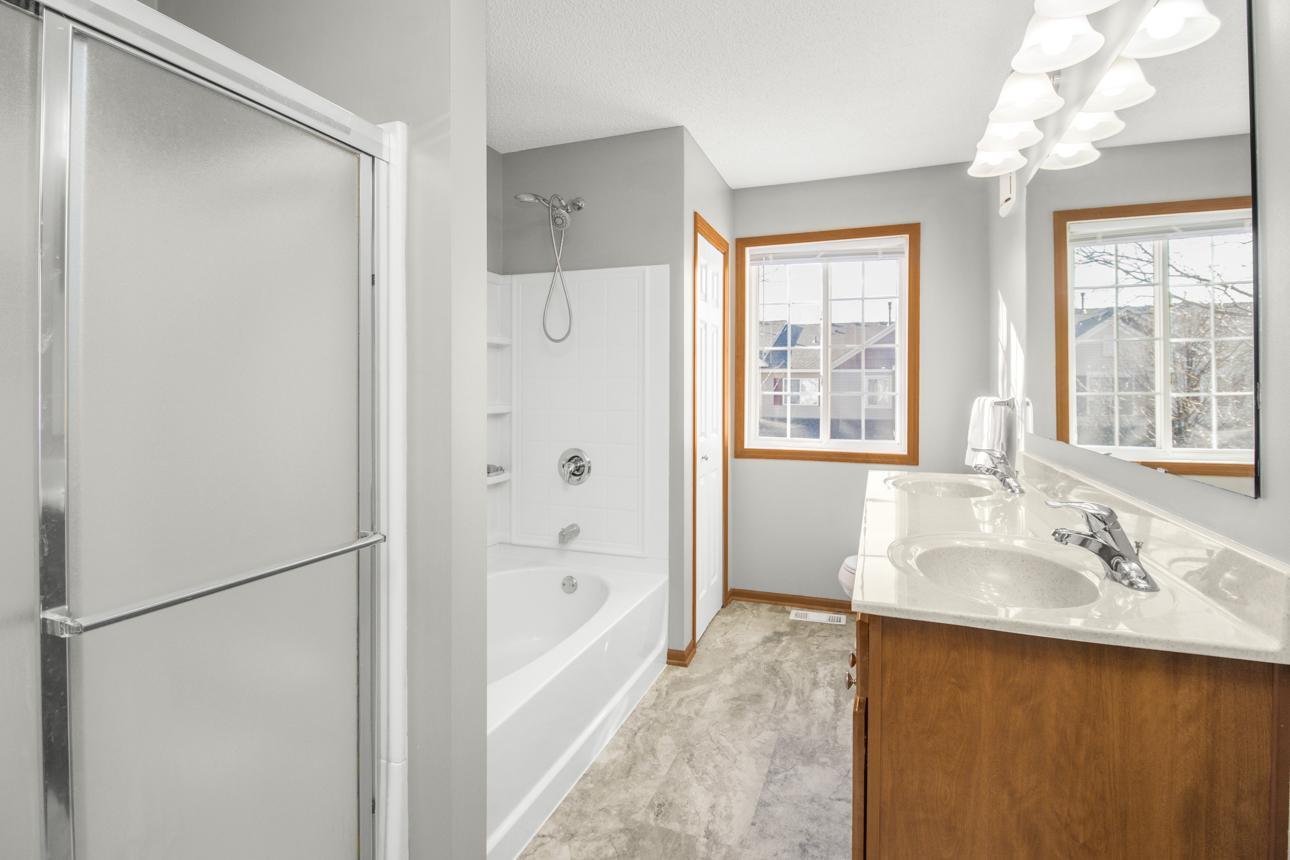 Huge bath with separate tub and two shower options! Dual sinks, good storage and is wonderfully sunny!