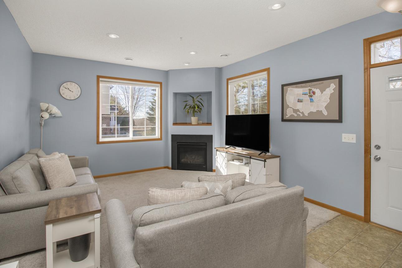 Enter the sun filled living room with gas burning fireplace, tall ceilings and tons of wall space for decor.