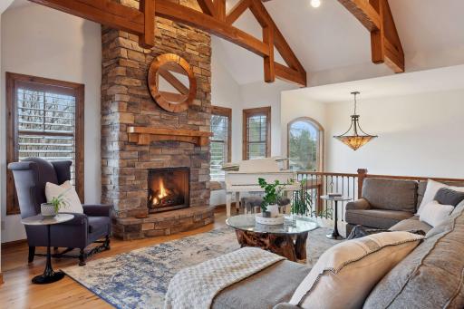 Views and natural light abound in this wonderful great room space. Relax and enjoy family time in front of this beautiful floor to ceiling stone fireplace.