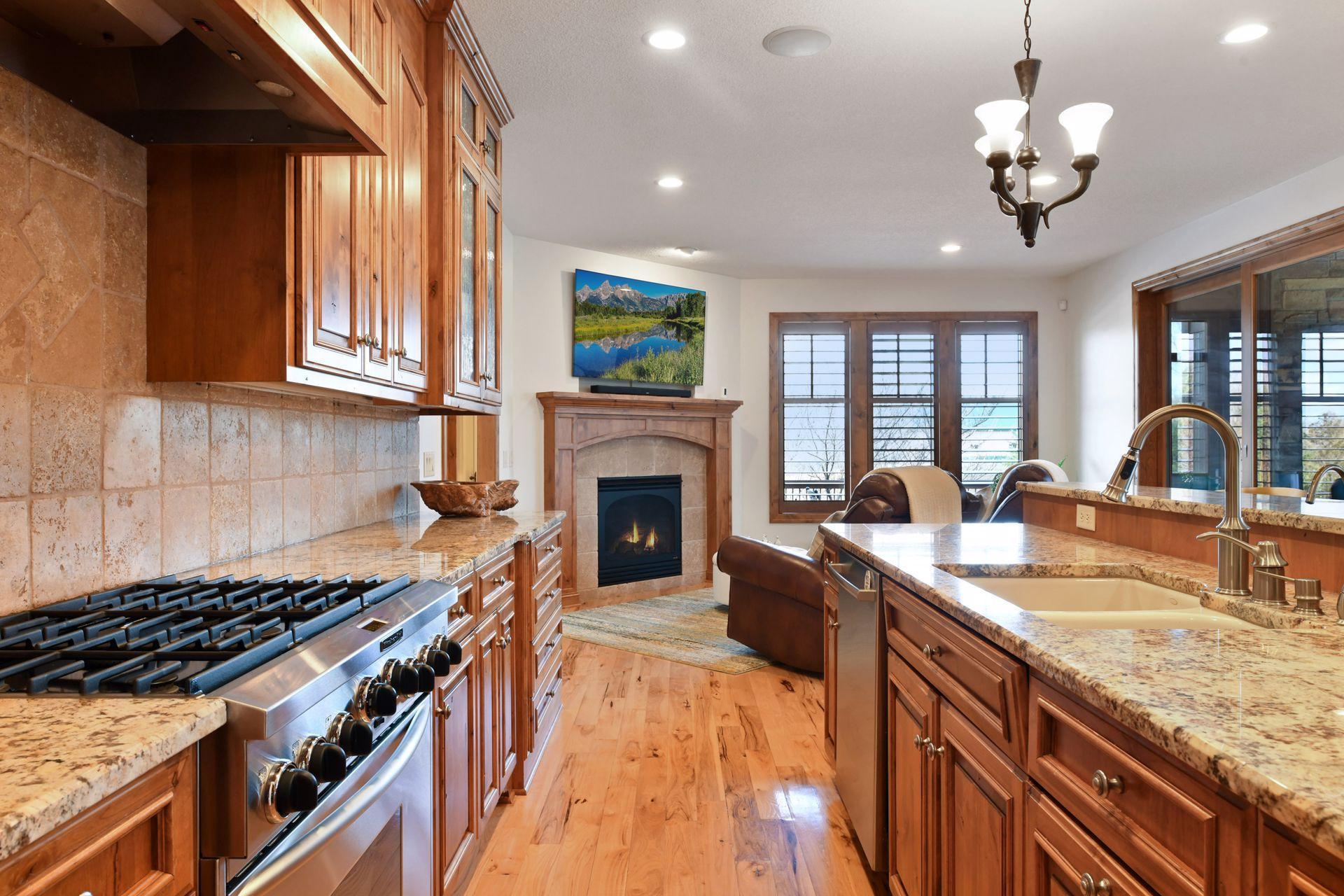 Stunning kitchen, beautiful Alder wood cabinetry, gorgeous granite countertops, 6 burner KitchenAid gas stove, with a charming attached sitting room with a gas fireplace.