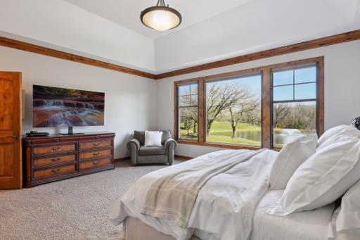 Large Primary Bedroom with gorgeous French doors, high ceilings, and large windows - perfectly located on the main floor giving this home all living facilities on 1 level.