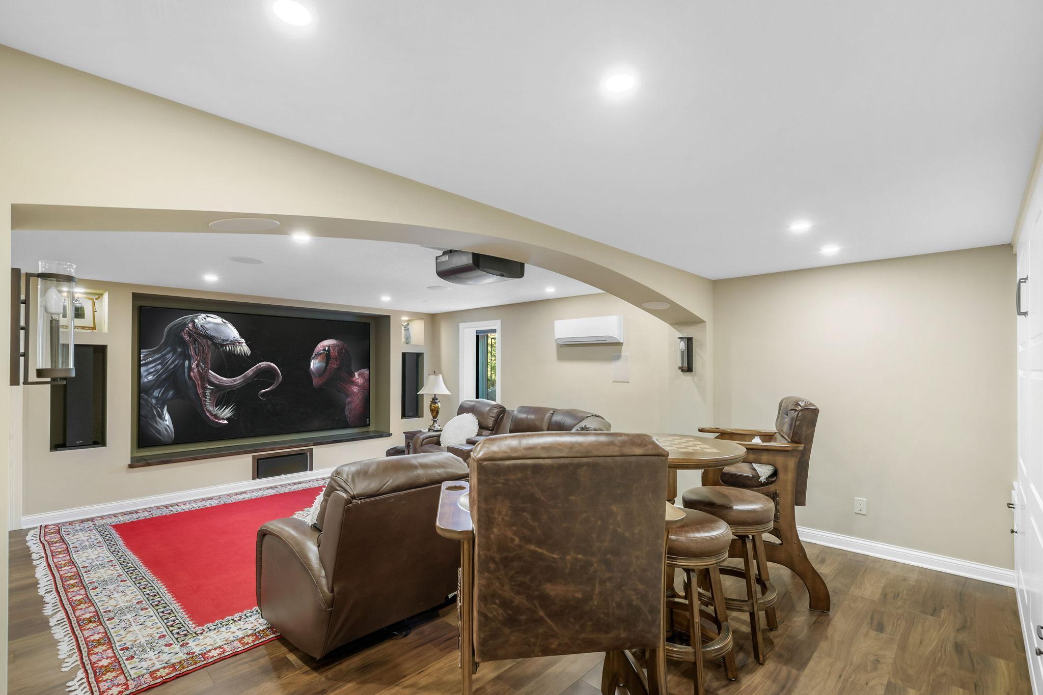 Multi-purpose Theater Room with foam insulation for maximum sound-proofing, 4k screen and projector, 9 channel Dolby HDR sound, and black-out blinds