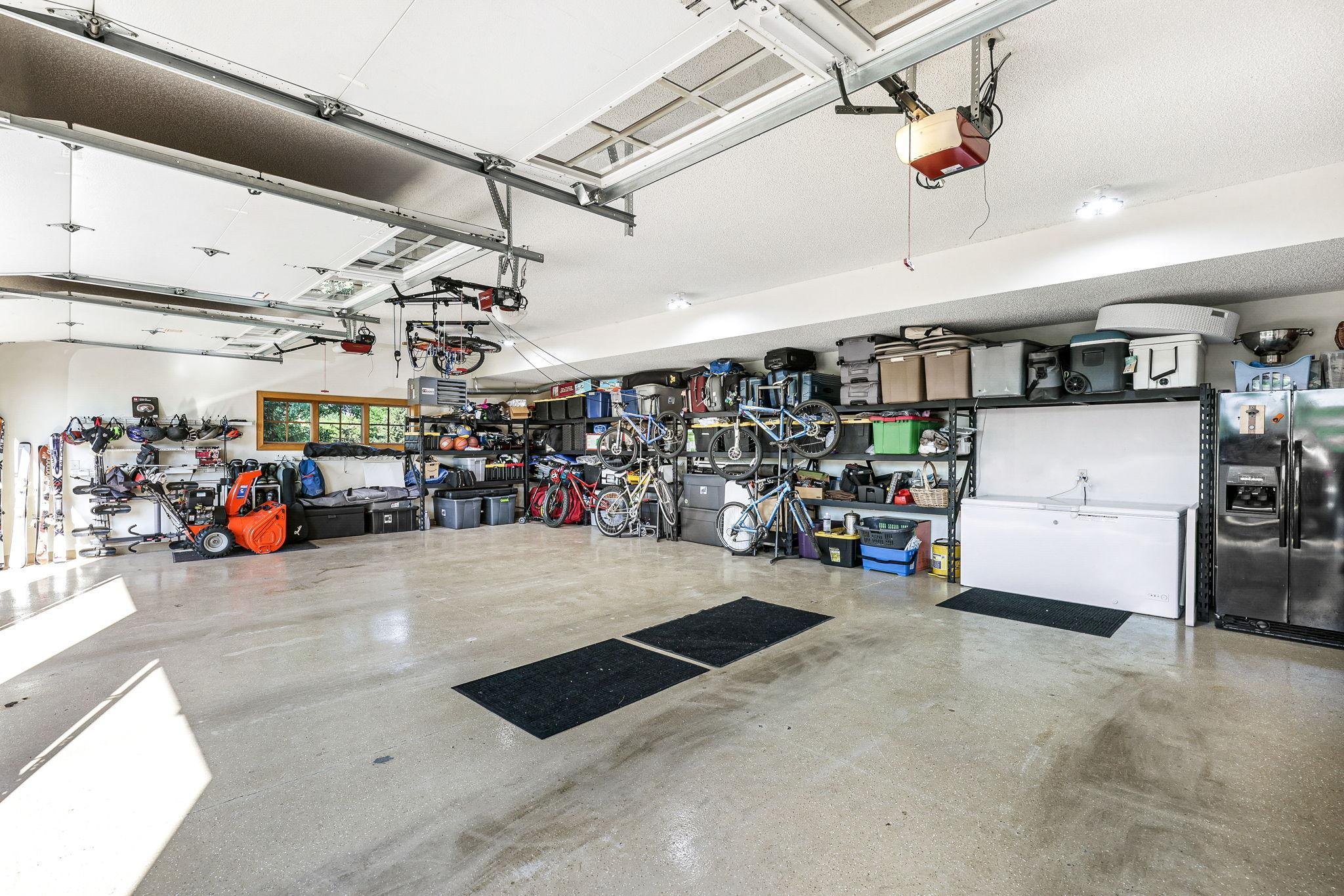 Attached 3 car heated and insulated garage including 2 charging stations for electric vehicles