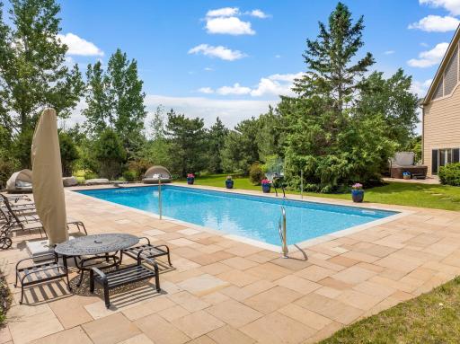 The massive 50x20 pool is heated with an automatic safety cover with beautiful stamped concrete surrounding it â every summer day will be a perfect pool day!