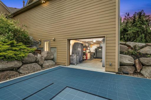Lower level tuck-under garage/work shop area opens to backyard/sports court area.
