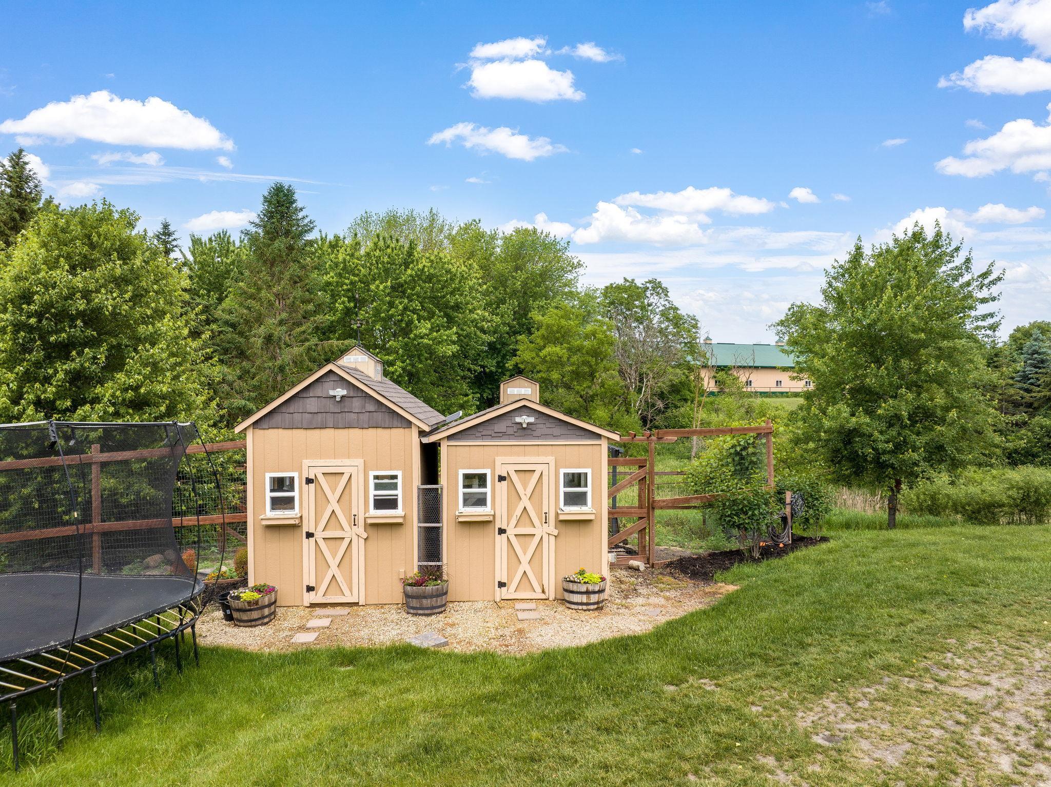 Charming and insulated chicken coops - includes a fenced run area with cover and pond.