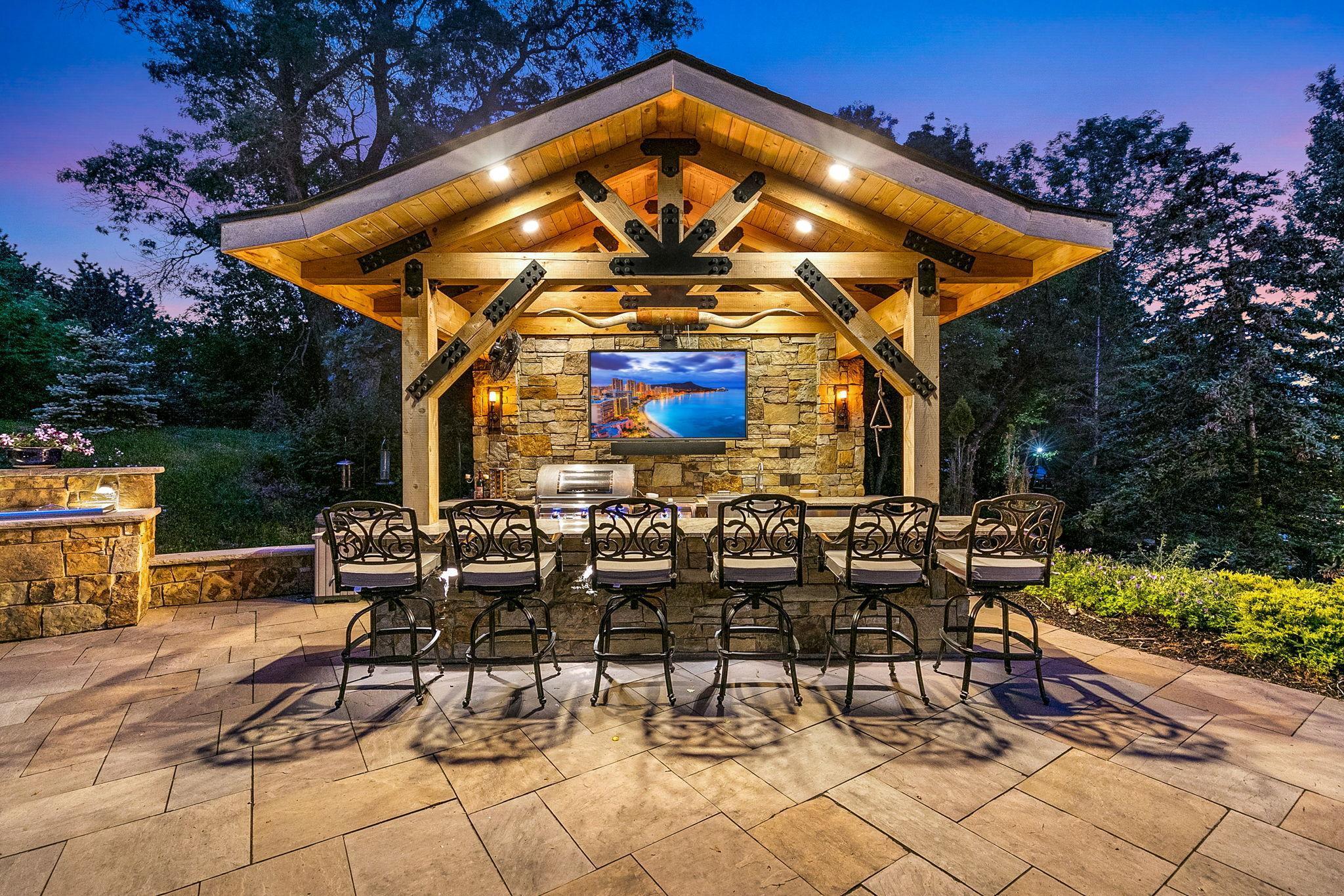 Bar area with Telescoping outdoor weather-proof TV and speaker that disappears into the roof system when not in use.